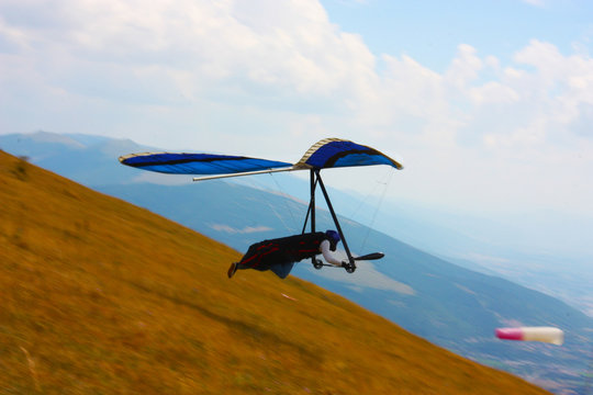 Hang glider pilot in Italian mountains