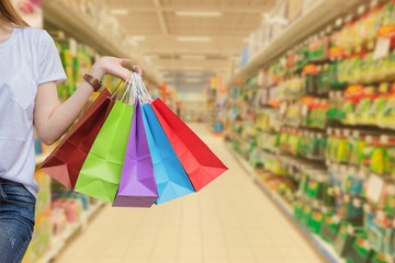 Young woman with shopping bags walking and shopping in supermarkets, Woman lifestyle concept 