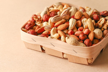 Dried fruits and nuts mix in a wooden bowl. 