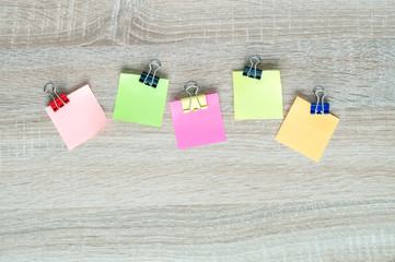 colorful stickers on a white A4 sheet on a wooden background