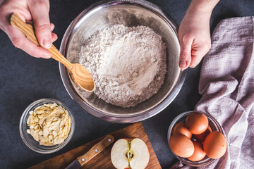 The cook mixes ingredients for apple pie. Ingredients for baking fresh pie. Top view. Toned photo