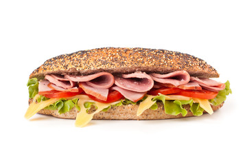 long whole wheat sub baguette sandwich with lettuce, tomatoes, ham, turkey  and cheese isolated on white