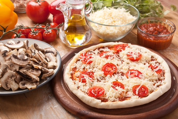 raw margarita pizza and ingredients