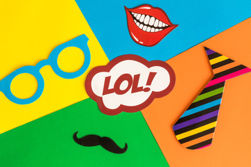 Flat lay of party set cardboard carnival masks abstract on multicolored background.