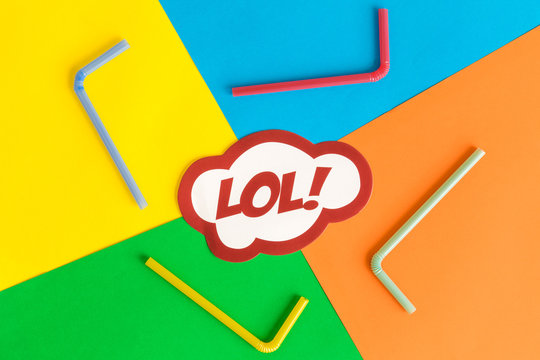 Lol text in speech bubble with drinking straws against multicolored background abstract.