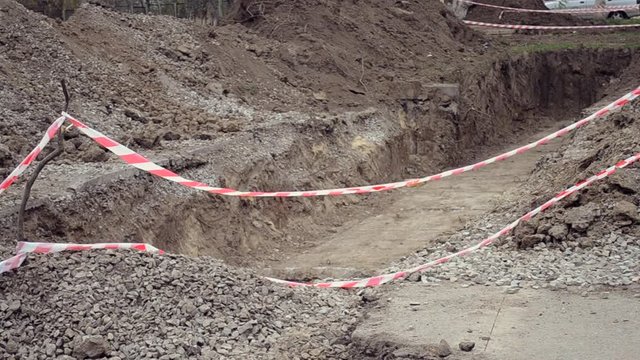 Pit dug protective red tape