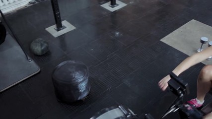 Female athlete working on her body in the gym. The girl is engaged in fitness