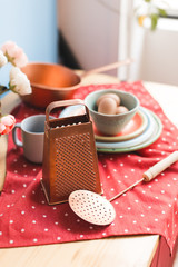 collection of vintage kitchenware with red tablecloth, blue background. Time for cozy breakfast 