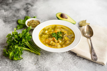 Tasty vegetables and spices soup on a gray concrete background. It can be used as a background