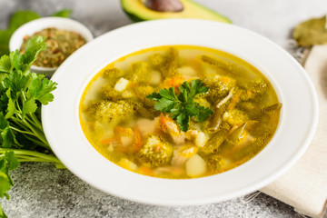 Tasty vegetables and spices soup on a gray concrete background. It can be used as a background