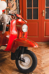 Retro red scooter  in oldschool vintage interior with air balloons