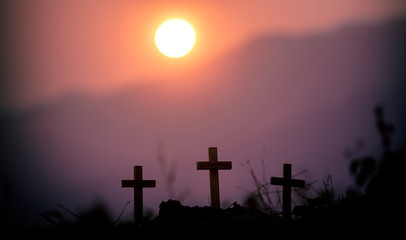 Three cross standing with light sunset background. christian silhouette concept