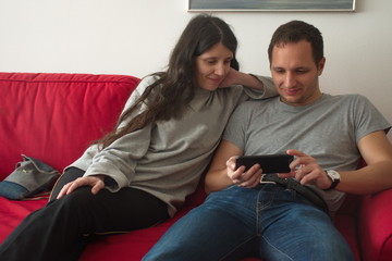 Young couple texting on the mobile phone