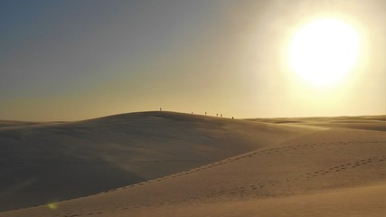 Naklejka na ściany i meble Dunes of Sand and Rainwater Pools at Dusk in Lençóis Maranhenses National Park looks like a Martian landscape