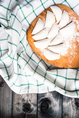 Raw dumplings sprinkled with flour on a kitchen board and a striped towel