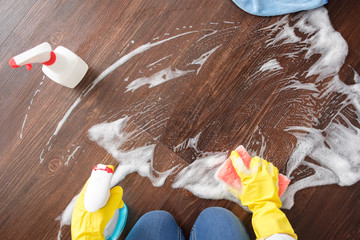 The girl washes the floor at home