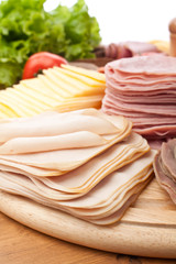 big group of thin sliced meat, bread and vegetables