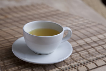 Green tea on a brown mat close-up