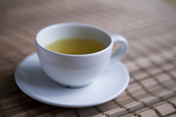 Green tea on a brown mat close-up