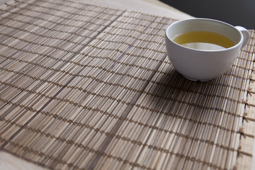 Green tea on a brown mat close-up