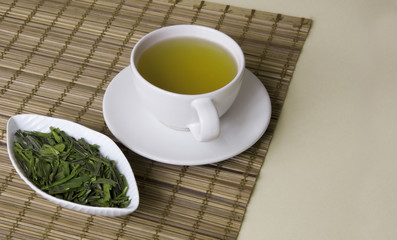 Green tea on a brown mat close-up