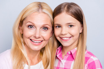 Close-up portrait of two nice cute charming attractive toothy lovely sweet tender gentle delicate cheerful people wearing casual isolated over gray pastel background