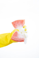 Hand squeezes out a sponge on a white background