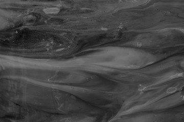 black and gray iridescent background. Marble, blending, blending. Design, abstraction, art.