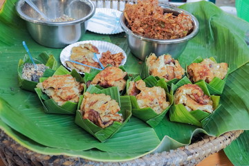 Delicious Thai Traditional Food, fried corn in banana leaf container.