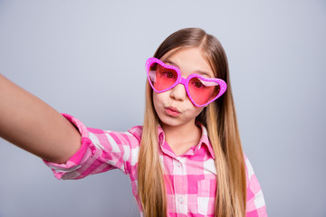 Close up photo blond haired she her little lady weekend holiday mood make take selfies send air kisses parents wear heart figure specs pink plaid checkered shirt outfit isolated grey background