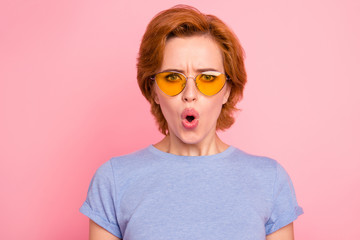 Close-up portrait of her she nice cute charming attractive lovely stunned girl wearing casual blue t-shirt yellow glasses opened mouth pouted lips isolated over pink pastel background