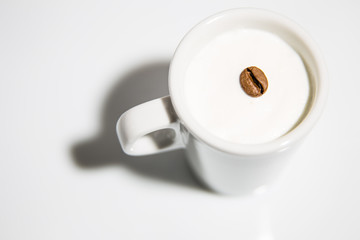 Coffee bean in a cup of milk
