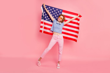 Full length body size view portrait of her she nice cute charming attractive cheerful girl holding in hands us flag green card win winner relocation isolated on pink pastel background