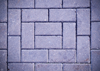 Obraz premium decorative paving tile on the sidewalk with vignette. background, texture, pattern.
