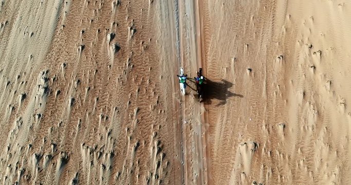 Horse riding in desert.