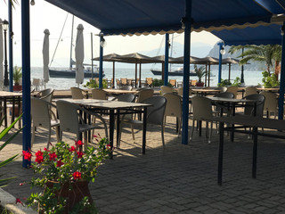 Greek tavern, restaurant, cafe on the beach. Dawn in the bay