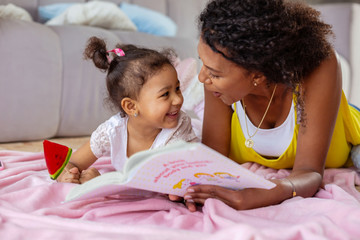 Cheerful young mother communicating with her daughter