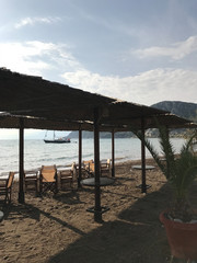 Greek tavern, restaurant, cafe on the beach. Dawn in the bay