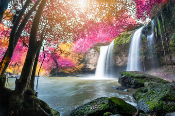 Fototapeta premium Amazing in nature, beautiful waterfall at colorful autumn forest in fall season 