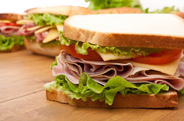 group of tasty sandwiches on a wooden table