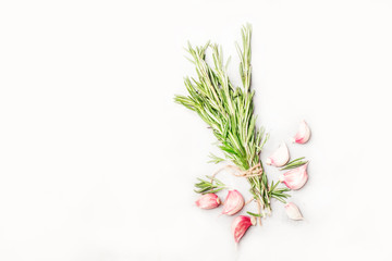 Fresh rosemary and red garlic on white spice food background, top view