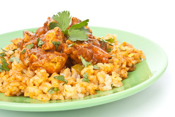 Chicken Curry with basmati rice and coriander leaves on a plate
