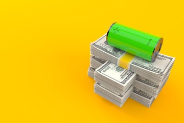 Green battery on stack of money
