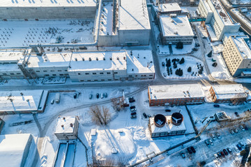 View of the urban industrial district from the air. Winter cityscape.
