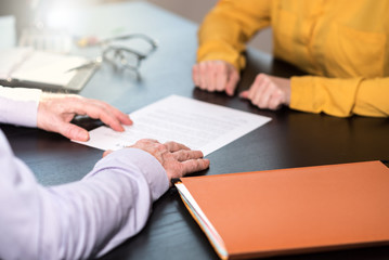 Business negotiation between businesswoman and businessman, light effect