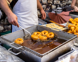 Frying homemade and delicious donuts on fresh olive oil. Typical spanish donuts