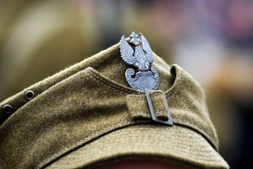 Eagle, Poland's emblem on the cap of a soldier from WWII during historical reconstruction.