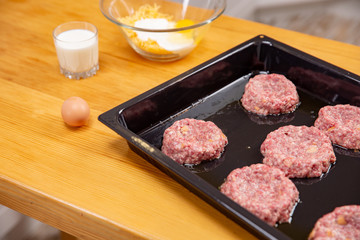 raw fresh veal cutlets in the shape of a flower or baking tray