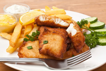 fish and chips on a plate on a wooden table