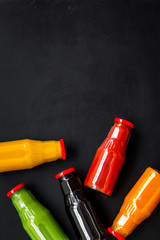 vegetable and fruit juice in bottles for diet drink on black background top view mock up